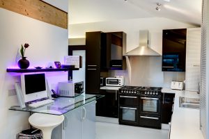 modern kitchen with a white computer on a glass table 